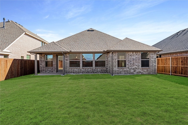 rear view of property featuring a yard