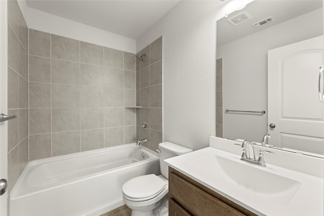 full bathroom with tiled shower / bath combo, toilet, and vanity