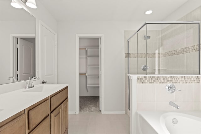 bathroom featuring tile patterned flooring, vanity, and shower with separate bathtub