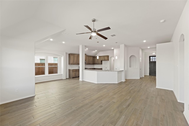 unfurnished living room with light hardwood / wood-style floors and ceiling fan