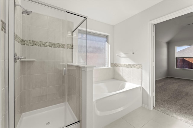 bathroom with tile patterned floors, plenty of natural light, and plus walk in shower