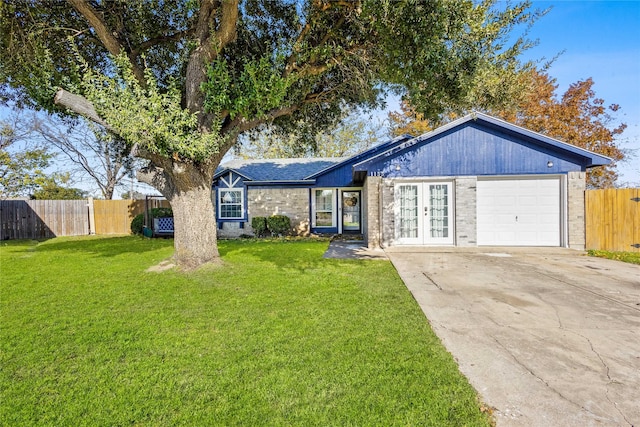 ranch-style home with french doors, a garage, and a front lawn