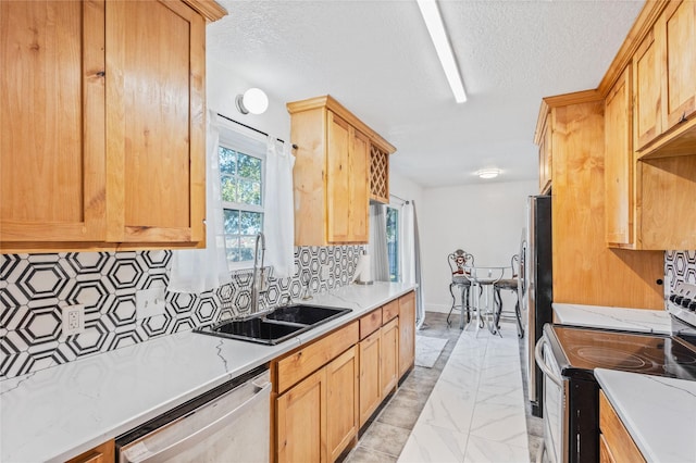 kitchen featuring sink, backsplash, stainless steel appliances, light stone countertops, and a textured ceiling