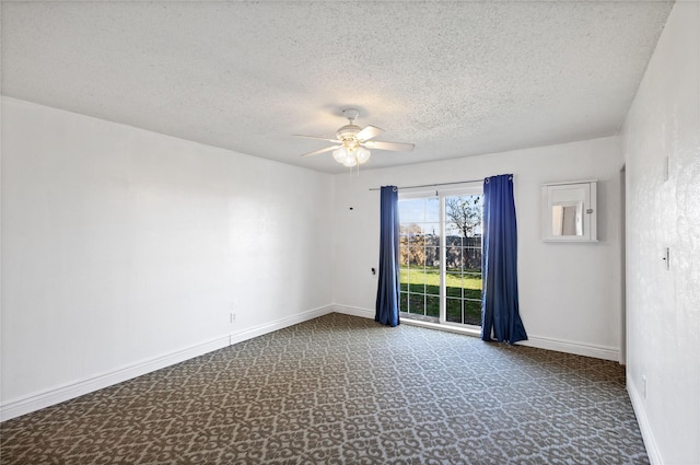 empty room featuring ceiling fan, carpet flooring, and a textured ceiling