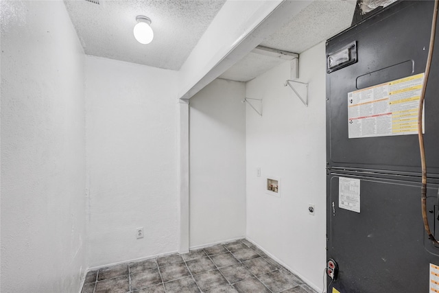 laundry area with electric dryer hookup, heating unit, washer hookup, and a textured ceiling