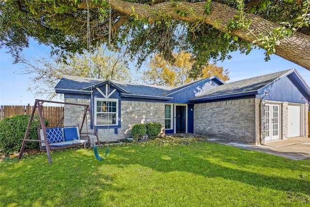 ranch-style house featuring a garage and a front yard