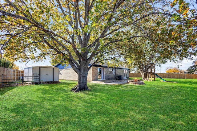 view of yard featuring cooling unit, a storage unit, a playground, and a patio