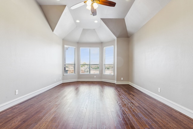 unfurnished room featuring dark hardwood / wood-style floors, vaulted ceiling, and ceiling fan