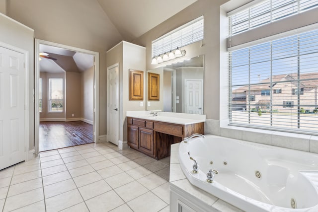 bathroom featuring tile patterned flooring, a healthy amount of sunlight, ceiling fan, and lofted ceiling