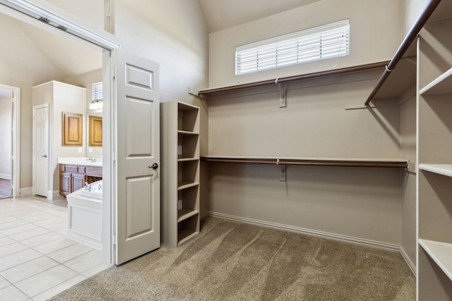 spacious closet featuring light carpet and lofted ceiling