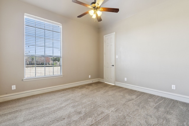 spare room with ceiling fan and carpet