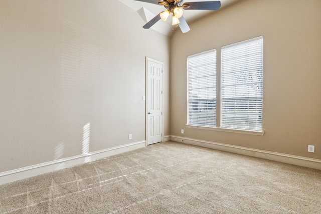 spare room featuring light carpet and ceiling fan