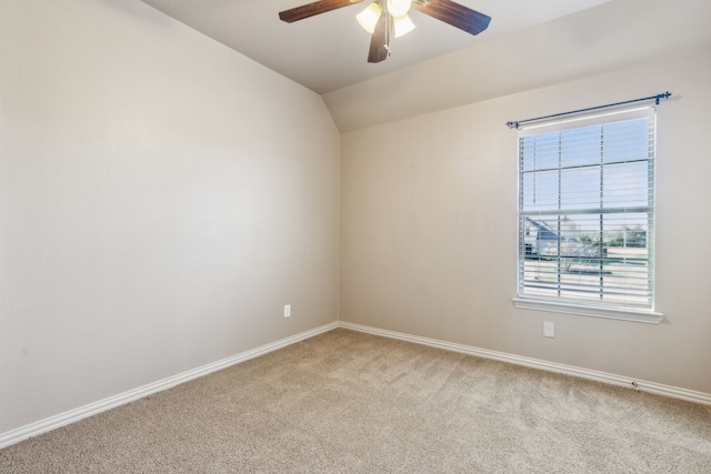 carpeted empty room with plenty of natural light, ceiling fan, and lofted ceiling