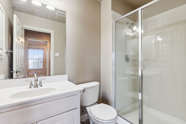 bathroom with vanity, toilet, and walk in shower