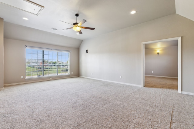 carpeted empty room with ceiling fan and lofted ceiling