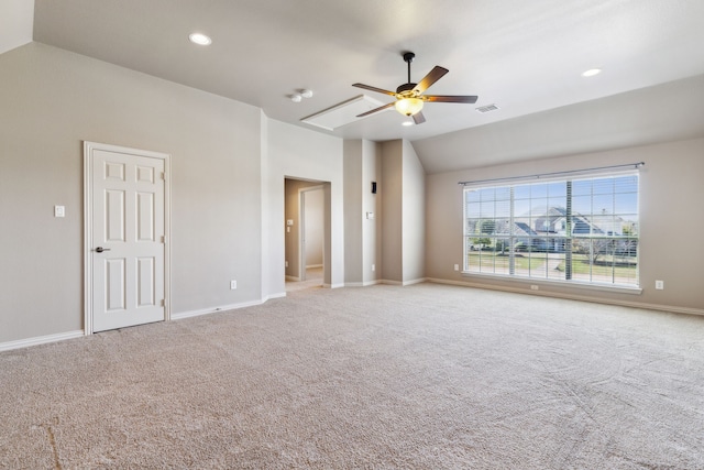 empty room with carpet flooring, vaulted ceiling, and ceiling fan