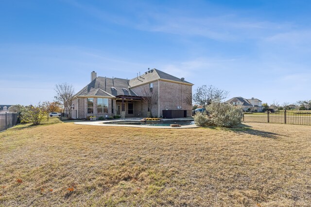 rear view of house with a yard