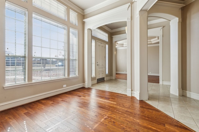 entryway featuring light hardwood / wood-style flooring and ornamental molding