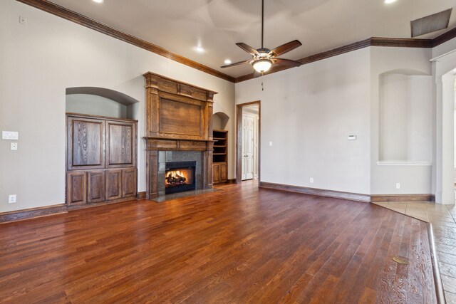 unfurnished living room with ceiling fan, wood-type flooring, and crown molding