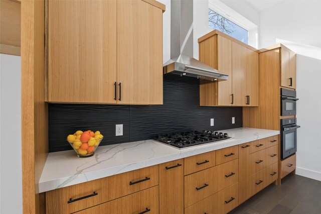 kitchen with light stone countertops, wall chimney exhaust hood, dark hardwood / wood-style floors, backsplash, and black appliances