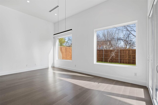 spare room featuring dark wood-type flooring