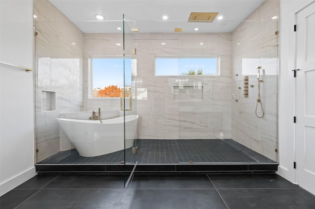 bathroom with tile patterned flooring and shower with separate bathtub