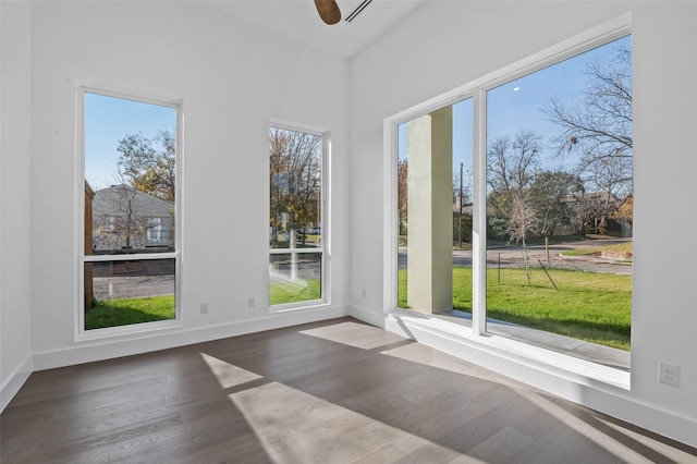 unfurnished sunroom with a wealth of natural light and ceiling fan