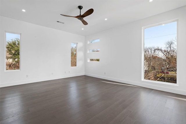 empty room featuring ceiling fan and dark hardwood / wood-style floors