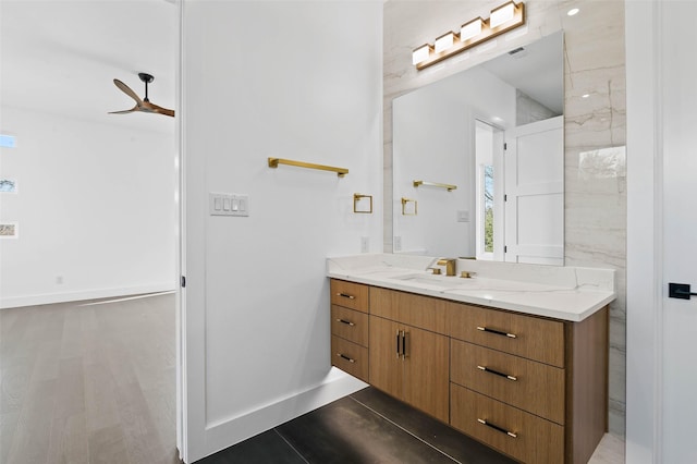 bathroom featuring hardwood / wood-style floors, vanity, and ceiling fan