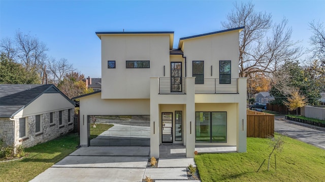 back of property with a balcony and a lawn