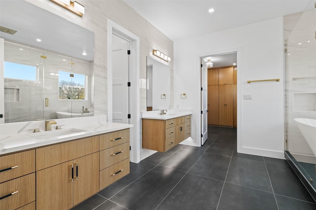 bathroom featuring plus walk in shower, vanity, tile patterned floors, and tile walls