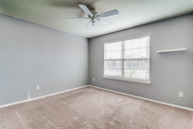 carpeted empty room with ceiling fan