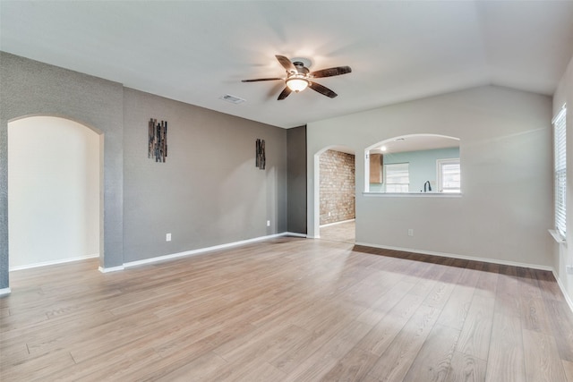 spare room with ceiling fan and light wood-type flooring