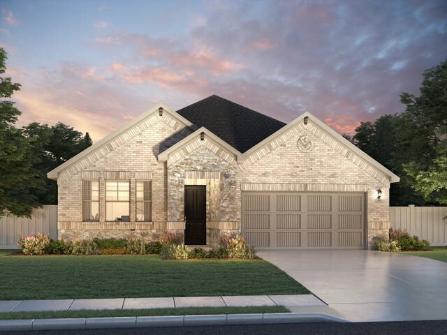 view of front facade featuring a lawn and a garage