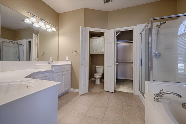 full bathroom featuring toilet, shower with separate bathtub, vanity, and tile patterned floors