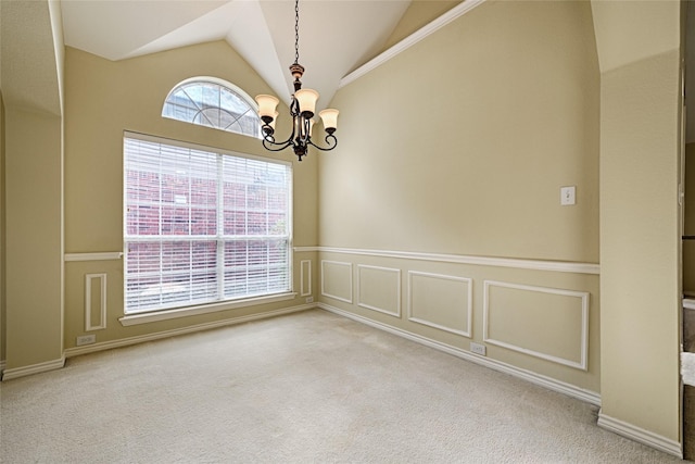 carpeted empty room with an inviting chandelier and lofted ceiling