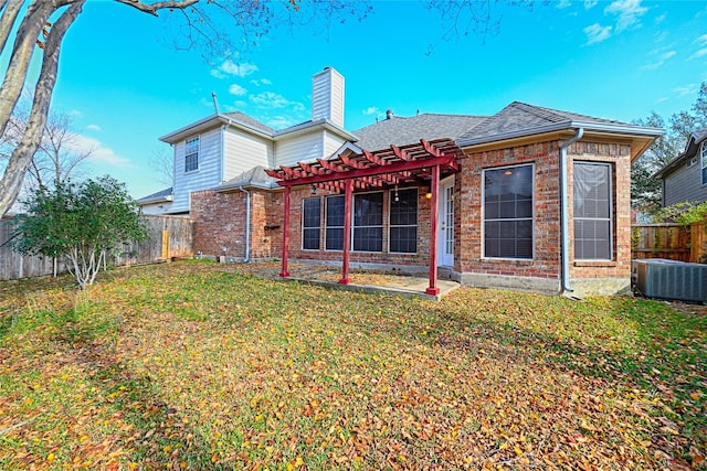 rear view of house featuring a pergola, a lawn, and central AC unit