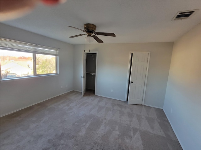 unfurnished bedroom featuring ceiling fan and light colored carpet