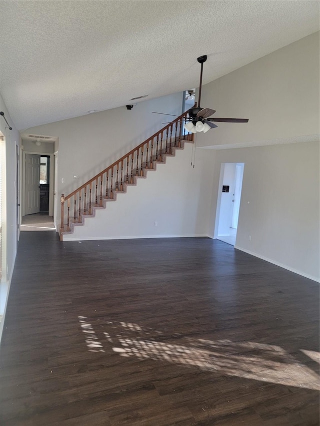 unfurnished living room with dark hardwood / wood-style floors, ceiling fan, lofted ceiling, and a textured ceiling