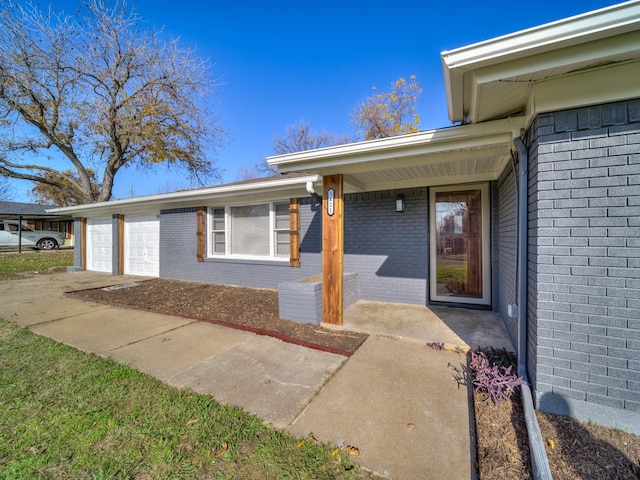 property entrance with a garage and covered porch