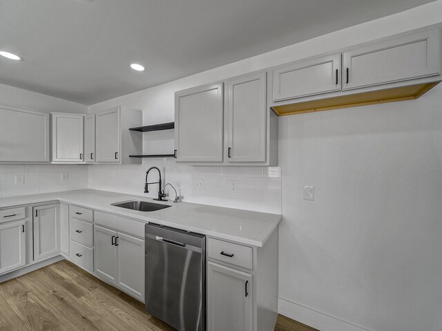 kitchen with dishwasher, decorative backsplash, light wood-type flooring, and sink