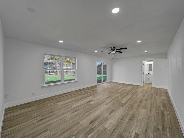 unfurnished living room featuring ceiling fan and light hardwood / wood-style flooring