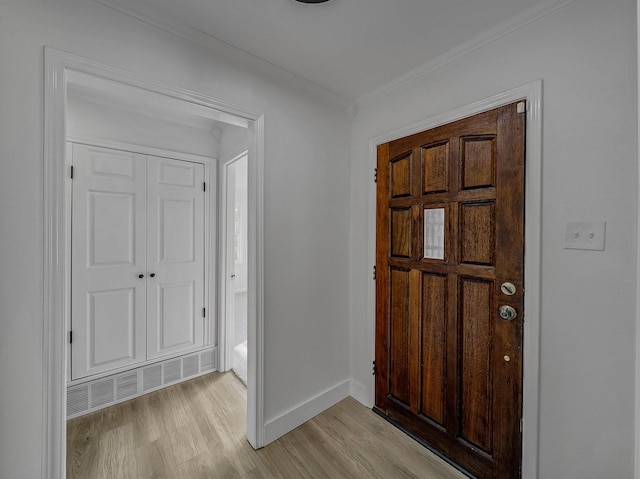 entrance foyer featuring light wood-type flooring and ornamental molding