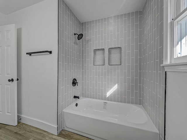 bathroom featuring tiled shower / bath combo and hardwood / wood-style flooring