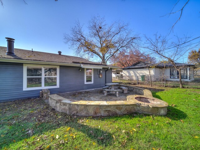 rear view of house featuring a yard