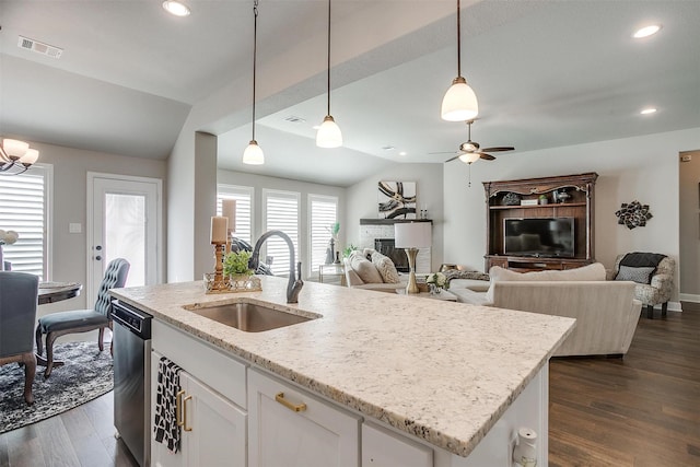 kitchen featuring sink, decorative light fixtures, dishwasher, white cabinetry, and lofted ceiling