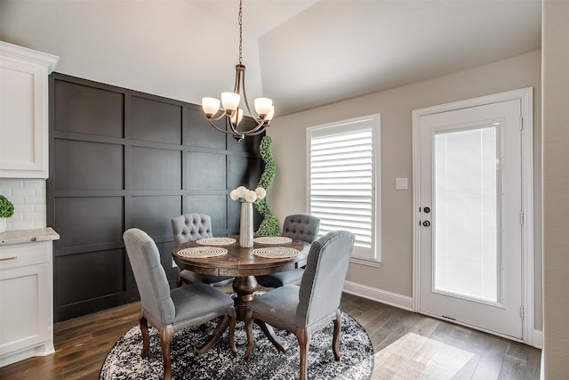 dining room featuring a notable chandelier and dark hardwood / wood-style flooring