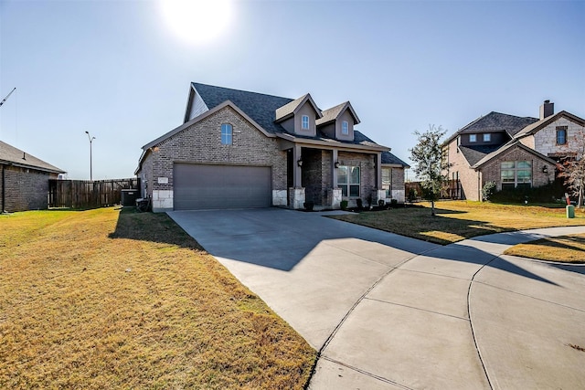 view of front of home featuring central AC unit, a garage, and a front lawn