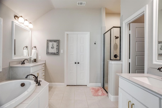 bathroom featuring tile patterned floors, vanity, vaulted ceiling, and shower with separate bathtub