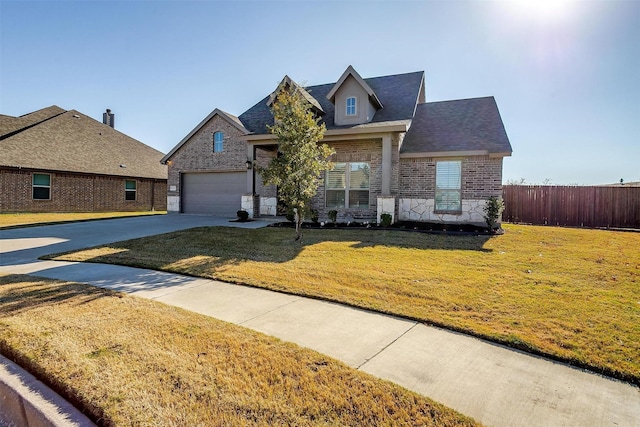 view of front of property featuring a garage and a front yard